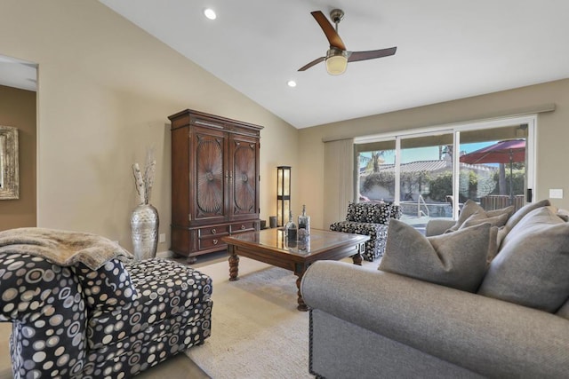 living room with ceiling fan, light colored carpet, and vaulted ceiling