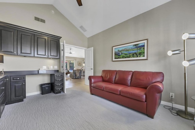 living room featuring lofted ceiling, light carpet, and ceiling fan