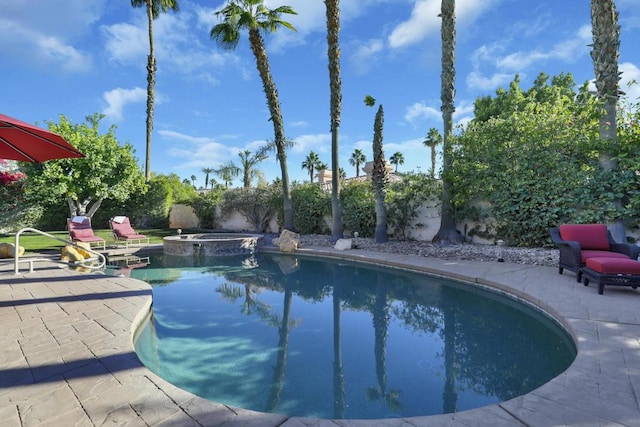 view of swimming pool featuring an in ground hot tub and a patio