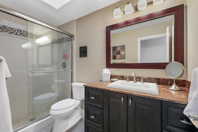 bathroom featuring walk in shower, vanity, and toilet