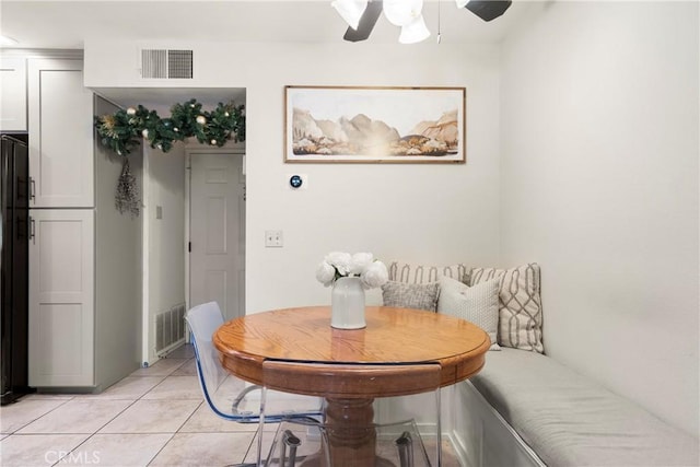 tiled dining space with ceiling fan and breakfast area