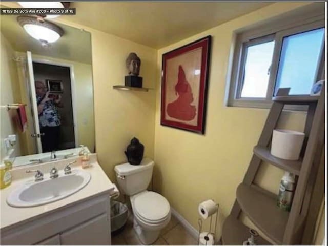 bathroom featuring vanity, tile patterned floors, and toilet