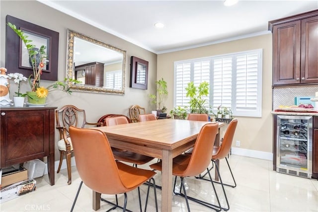 dining room with crown molding, light tile patterned floors, and beverage cooler