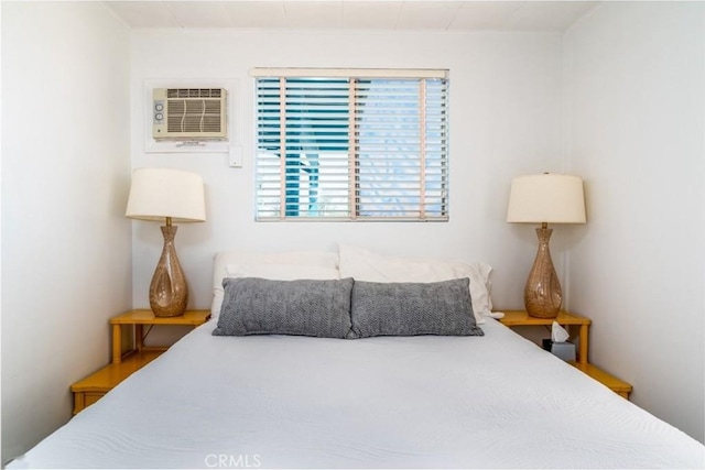 bedroom featuring a wall mounted AC