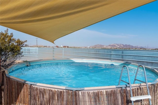 view of pool with a water and mountain view