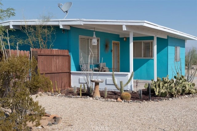 back of house featuring a porch