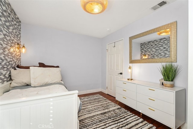 bedroom with dark wood-type flooring