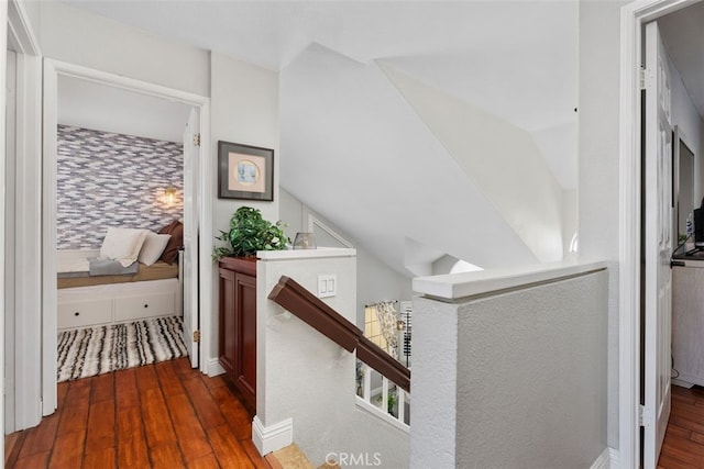 hall featuring lofted ceiling and dark hardwood / wood-style floors