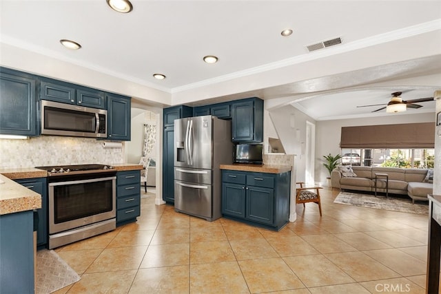 kitchen with light tile patterned floors, tasteful backsplash, blue cabinetry, appliances with stainless steel finishes, and ceiling fan