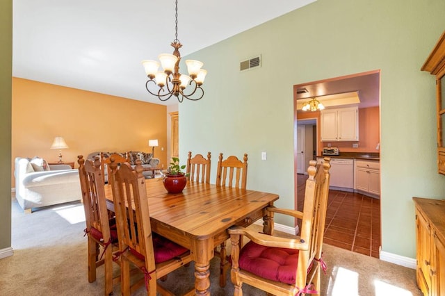 dining room with a notable chandelier, sink, and carpet flooring