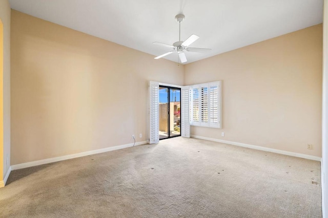 carpeted spare room with ceiling fan