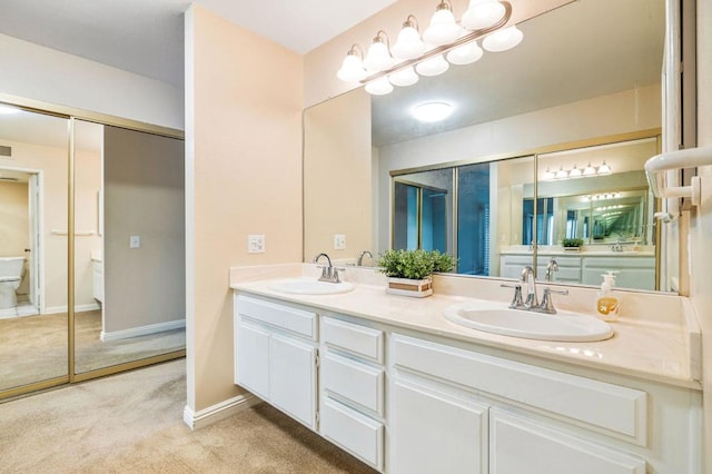 bathroom featuring toilet and vanity