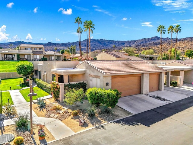 view of front facade featuring a garage and a mountain view