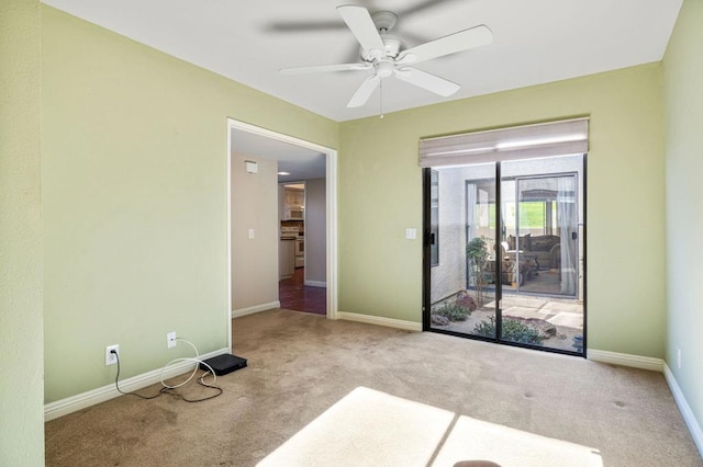 carpeted spare room with ceiling fan