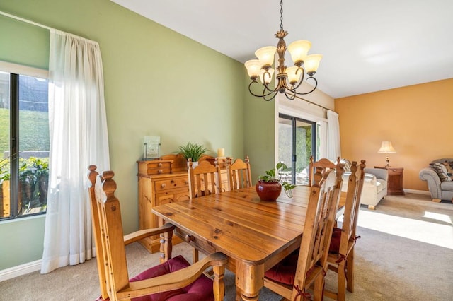 dining area featuring carpet floors and a chandelier