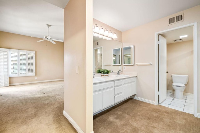 bathroom with toilet, vanity, tile patterned flooring, and ceiling fan