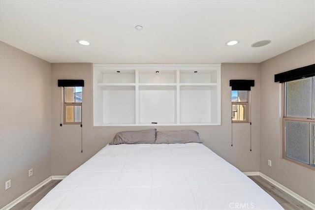 bedroom featuring multiple windows and light hardwood / wood-style floors