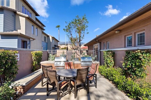 view of patio with exterior kitchen and grilling area