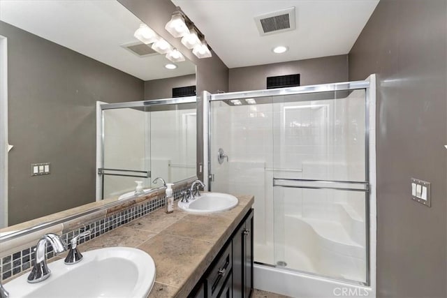 bathroom featuring an enclosed shower, backsplash, and vanity