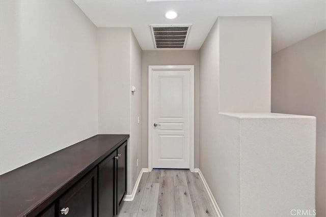 corridor with light hardwood / wood-style flooring