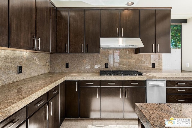 kitchen featuring light tile patterned flooring, stainless steel gas stovetop, backsplash, and dark brown cabinetry