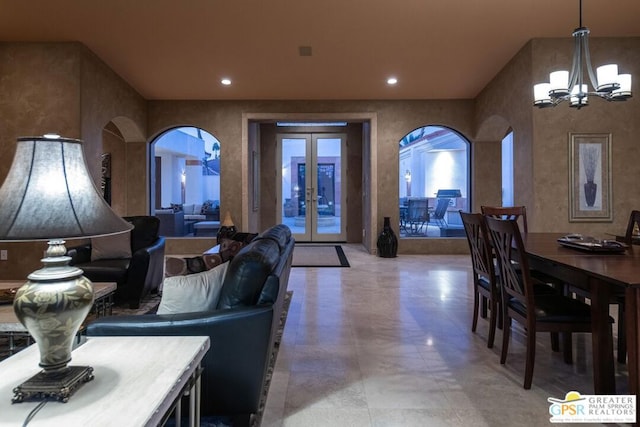 dining area featuring french doors and a chandelier