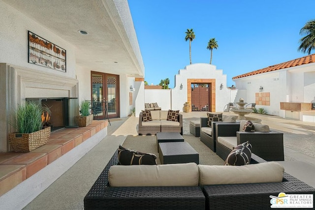 view of patio / terrace with an outdoor living space with a fireplace