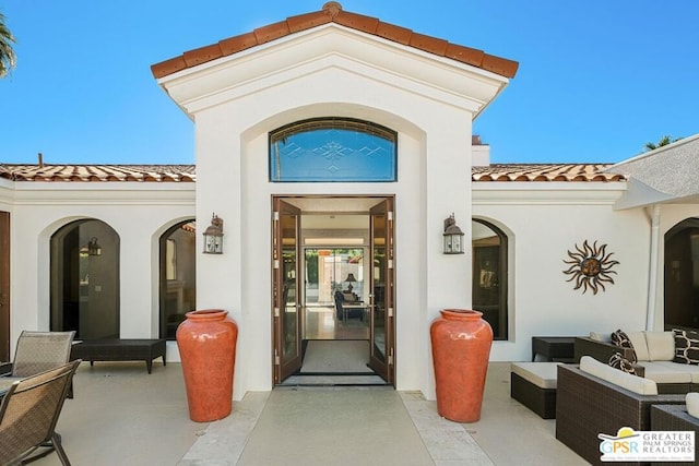 doorway to property featuring a patio and an outdoor living space