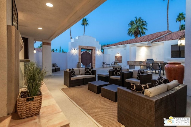 patio terrace at dusk featuring outdoor lounge area