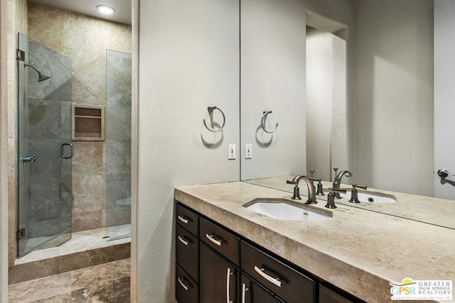 bathroom featuring vanity and a shower with shower door