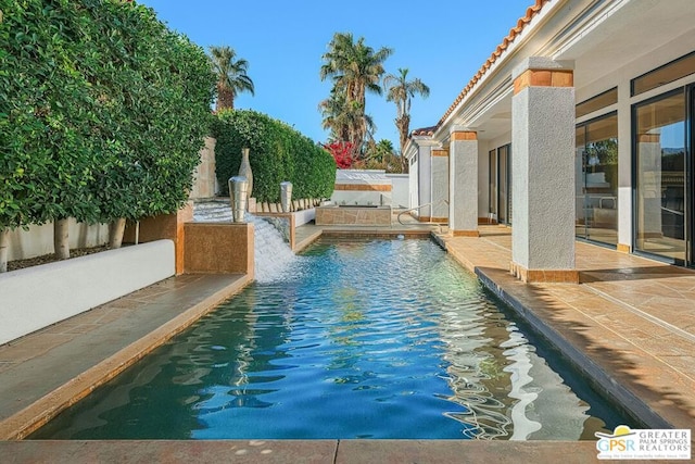 view of swimming pool with a patio area