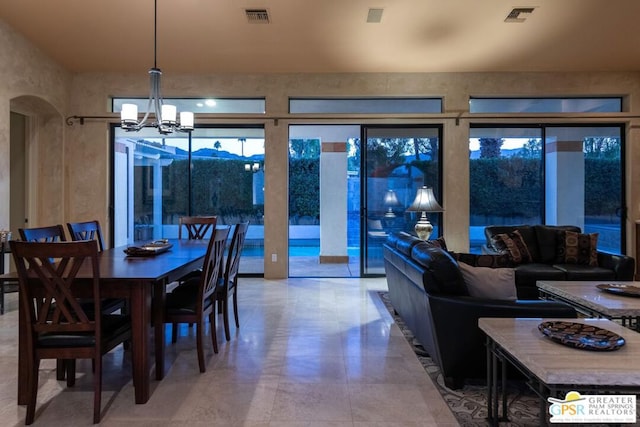 dining space with a chandelier