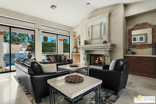 living room with lofted ceiling and a fireplace