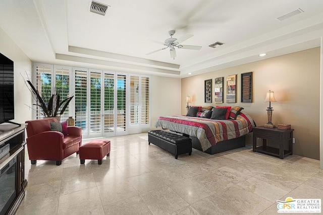 bedroom with access to outside, ceiling fan, and a tray ceiling