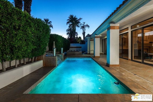 view of swimming pool featuring a patio