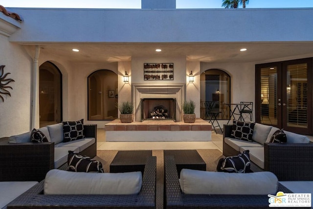 view of patio featuring an outdoor living space with a fireplace