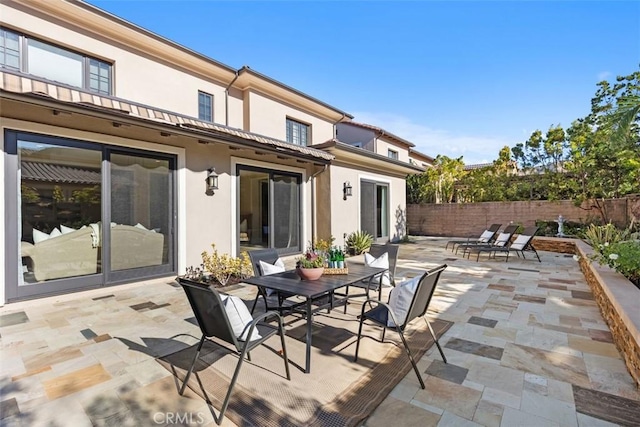 view of patio / terrace featuring fence and outdoor dining area