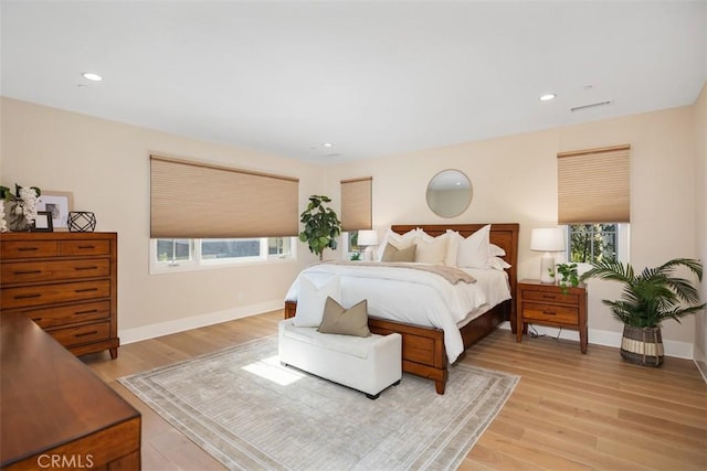 bedroom featuring light wood finished floors, recessed lighting, visible vents, and baseboards