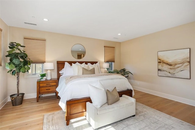 bedroom with light wood finished floors, visible vents, baseboards, and recessed lighting