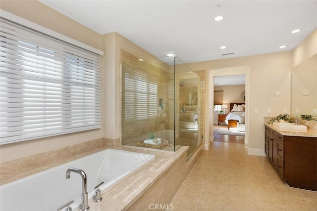 full bathroom featuring tile patterned flooring, connected bathroom, vanity, a shower stall, and a bath