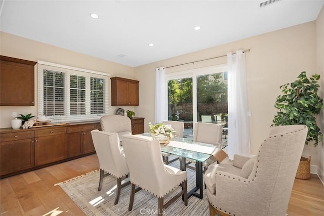 dining room featuring light wood-type flooring and recessed lighting