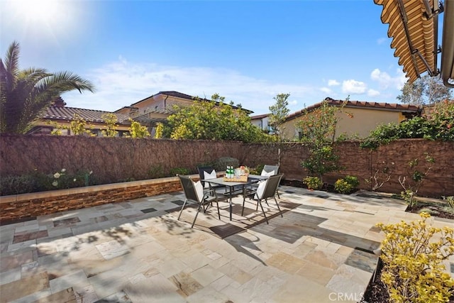 view of patio / terrace featuring outdoor dining area and a fenced backyard