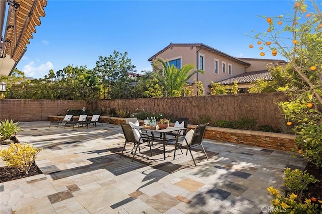 view of patio featuring fence private yard and outdoor dining space