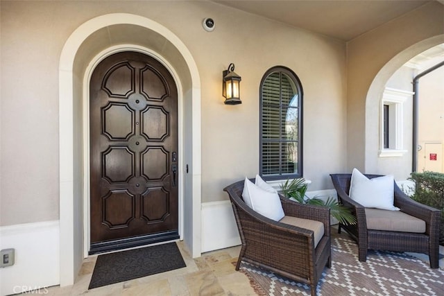 doorway to property featuring stucco siding