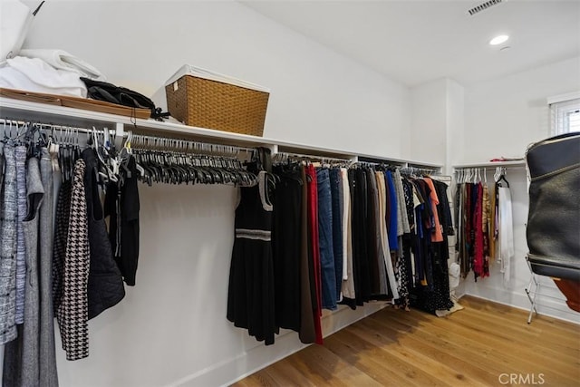 walk in closet featuring wood finished floors and visible vents