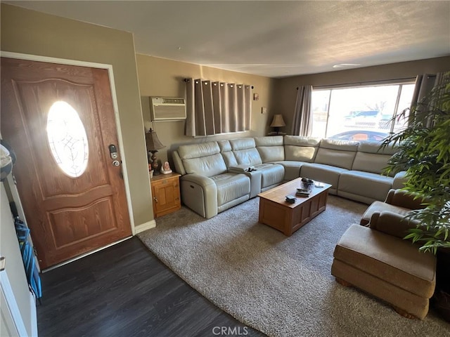 living room with a wall unit AC and dark hardwood / wood-style floors