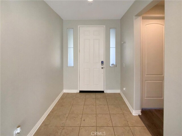 foyer entrance with light tile patterned floors