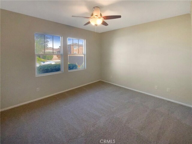 carpeted empty room featuring ceiling fan