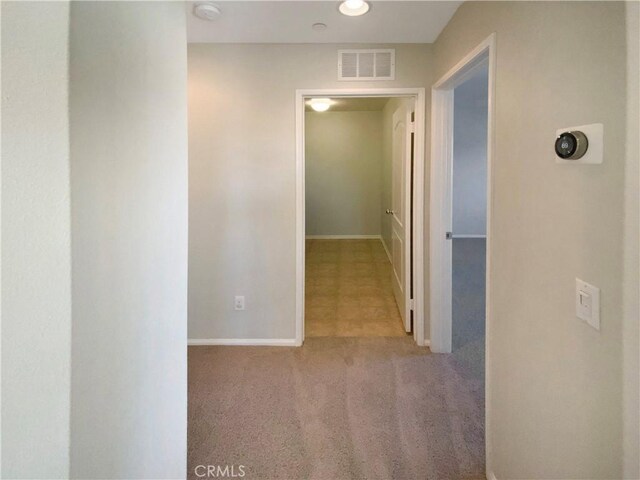 hall featuring light colored carpet