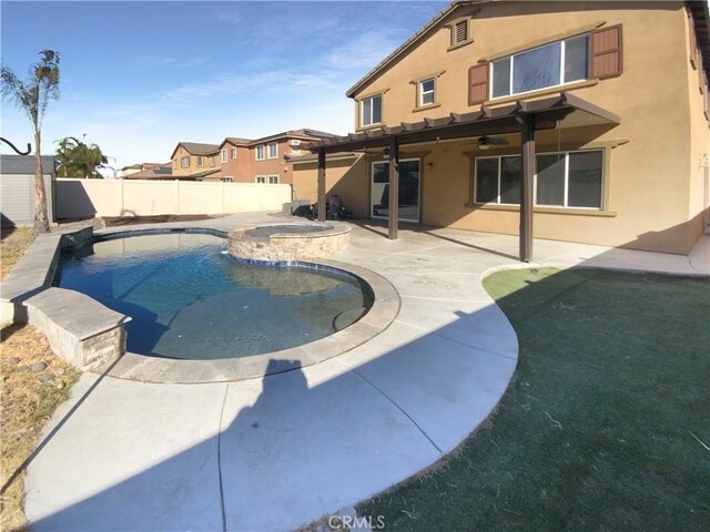 view of pool with a patio area and an in ground hot tub